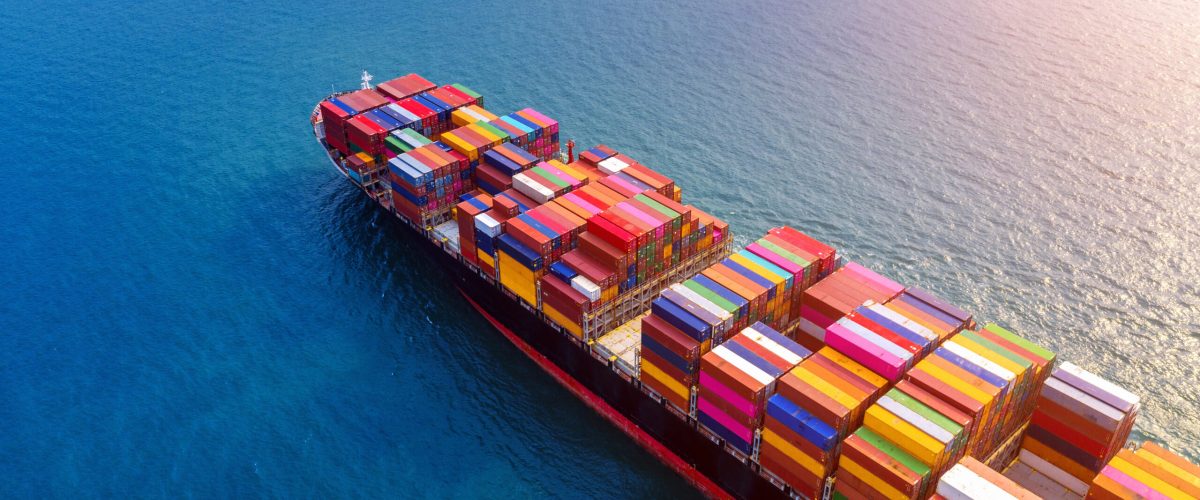 Aerial view of container cargo ship in sea.
